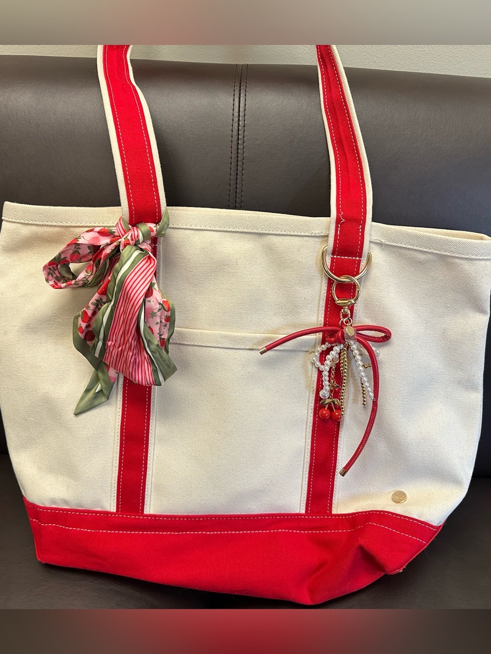 Cream Canvas Tote with Red Trim and Decorative Charm